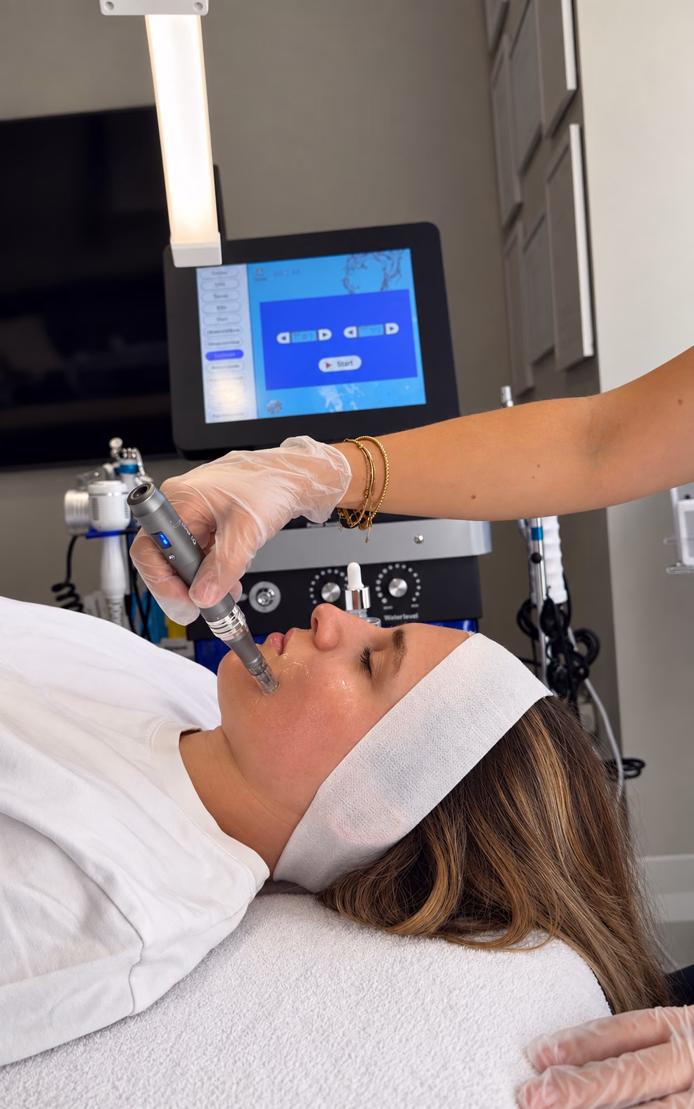 A practitioner performing microneedling on a client’s face